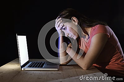 Depressed worker or student woman working with computer alone late night in stress Stock Photo