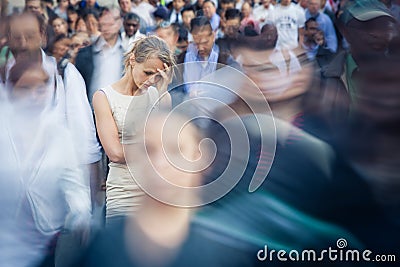Depressed young woman feeling alone amid a crowd of people Editorial Stock Photo