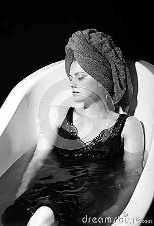 Depression concept. Sad woman in bath. Sadness, fatigue or grief, frustration. Alone upset girl. Stock Photo