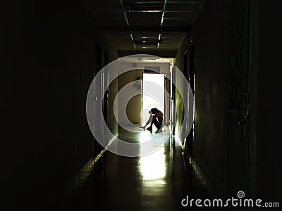 The depression young girl sitting in the dark, Domestic violence, family problems, Stress, violence, The concept of depression and Stock Photo