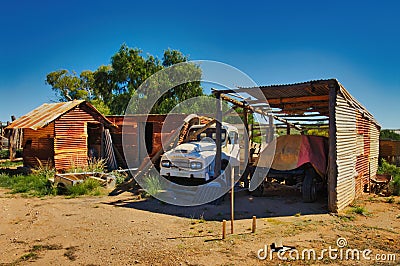 Derelict abandoned farm buildings and an old truck in the desert of South Australia Stock Photo