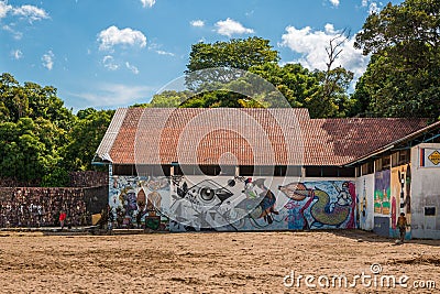 Derelict building with young Brazilian boy kicking a football near Ponta Negra beach in Manaus, Amazon, Brazil Editorial Stock Photo