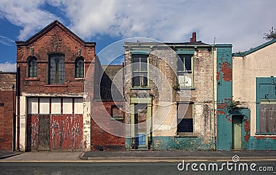 Derelict houses and abandoned garage on a residential street Stock Photo