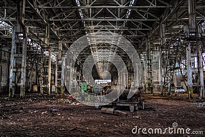 Derelict large dark industrial machinery hall of abandoned factory Stock Photo