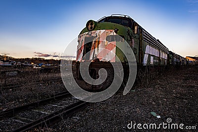 Derelict Locomotive at Twilight - Abandoned Railroad Trains Stock Photo