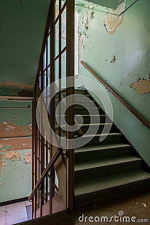 Derelict Staircase with Peeling Paint - Abandoned Laurelton State Hospital - Pennsylvania Stock Photo