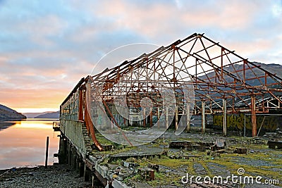 Derelict warehouse at Sunset over Loch Long Stock Photo