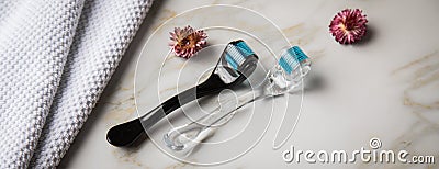 Derma roller for anti ageing lifting cosmetic treatment in cosmetologist beauty salon with marble background and dried blossoms Stock Photo