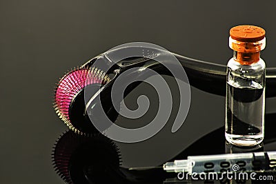 Derma roller for medical micro needling therapy with syringe and vial Stock Photo