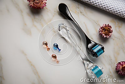 Derma roller and natural cosmetic vial ampoule for anti ageing lifting cosmetic treatment in cosmetologist beauty salon Stock Photo