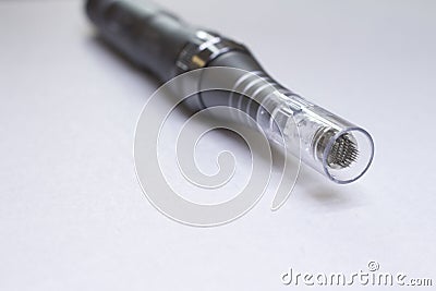 Dermis stamp electric pen. Dermapen. Needle mesotherapy treatment. Stock Photo