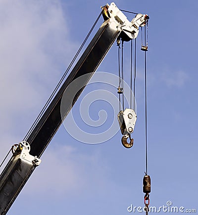 Derrick boom crane with hook Stock Photo