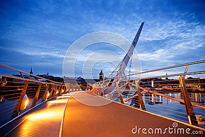 Derry, Ireland. Illuminated Peace bridge in Derry Londonderry, City of Culture, in Northern Ireland with city center at Editorial Stock Photo