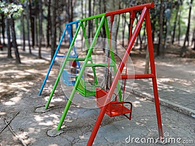 colorful swings in the park, swing in the garden, empty swings in the playground Stock Photo