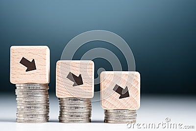 Descending Arrow Sign on Money Heap Stock Photo