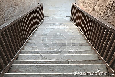 Descending a wooden staircase, steps and railings fill the frame Stock Photo