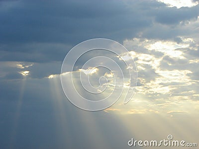 Descent of Divine Blessings from Sky - Sun Rays through Clouds Stock Photo