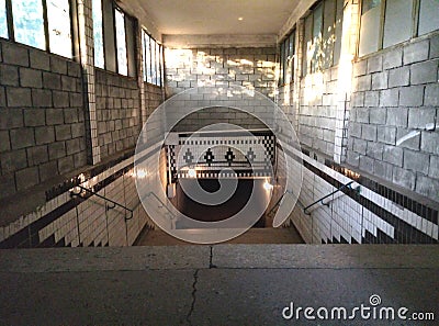 The descent into the pedestrian tunnel is empty without people. Staircase down to the underground new passage. Stock Photo