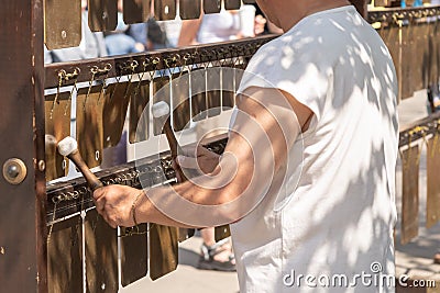 a man on the street playing music on metal plates Stock Photo