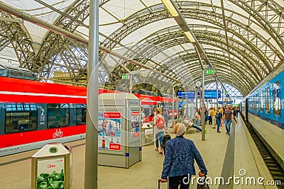 DESDREN, GERMANY - MARZO 23, 2016: Unidentified passengers arriving to train departure, nice roof Editorial Stock Photo