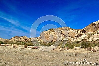 Desert landscape transitioning into dry rocky mountains Stock Photo