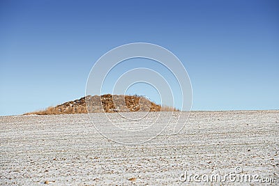 Desert, nature and landscape of environment with hill or countryside with grass, sand and blue sky. Mountain, peak and Stock Photo