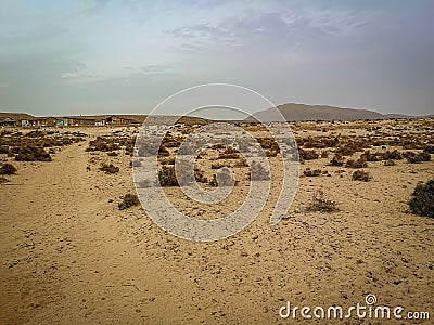 Desert road to an old village Stock Photo