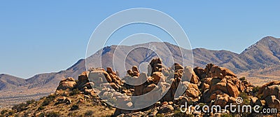 Desert Terrain Mountain Rocks against a bright Blue Cloudless Sky Stock Photo