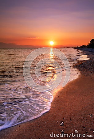 Deserted beach at sunset Stock Photo