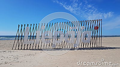 Deserted sandy beach on Baltic Sea and name of Latvian city Liepaja during Covid 19 on sunny day in April 2020 Editorial Stock Photo
