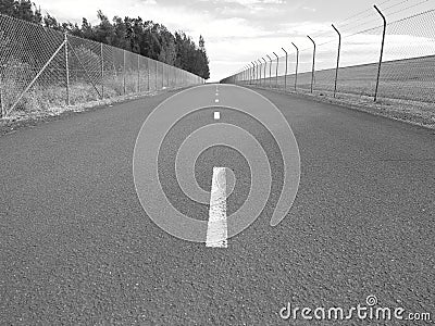 Fences at empty street depressing scenery in Australia, monochrome image Stock Photo