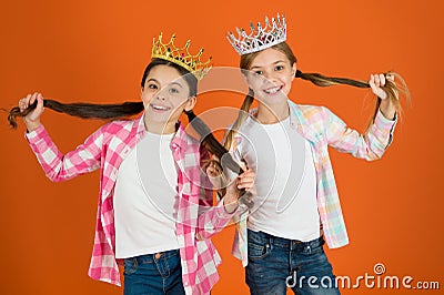 We deserve only best. Girls wear crowns. Spoiled children concept. Egocentric princess. Kids wear golden crowns symbol Stock Photo