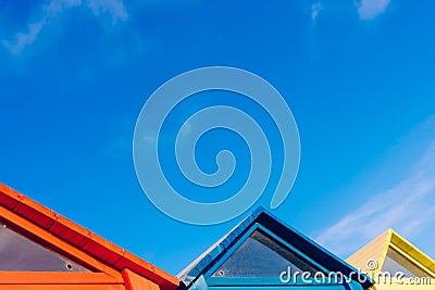 Design of colorful wooden triangular boards with blue sky background with clouds Stock Photo