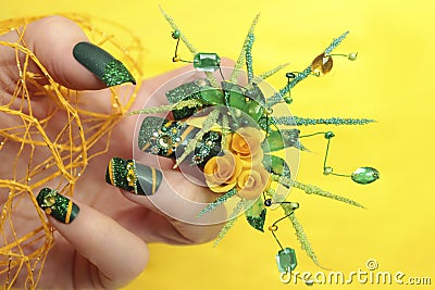 Design green acrylic nails with yellow roses . Stock Photo