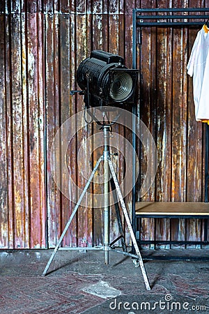 Design of loft Interior of dressing room. Metal wall and cinema lightning and white t-shirt on background. Copyspace for Stock Photo