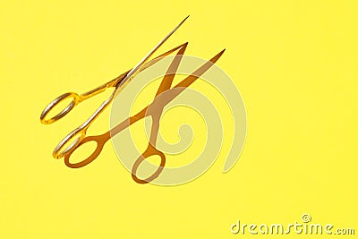 Design photo of scissor on vivid yellow background Stock Photo