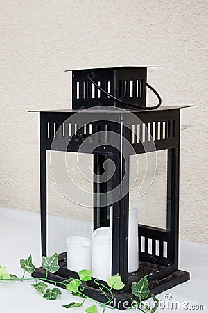 Design vintage modern black metal lantern with white candle light Stock Photo