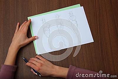 Designer assessing fashion drawings Stock Photo