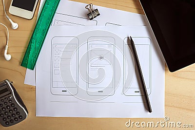 Designer desk with paper prototype of a mobile application Stock Photo