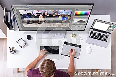 Designer Editing Photo On Computer Stock Photo