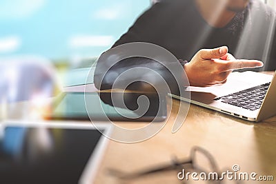 Designer hand working with digital tablet computer and smart phone on marble desk as responsive web design concept,sun flare Stock Photo