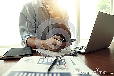 Designer hand working and smart phone and laptop on wooden desk Stock Photo