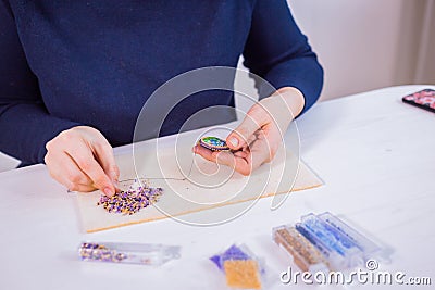 Designer making handmade brooch Stock Photo