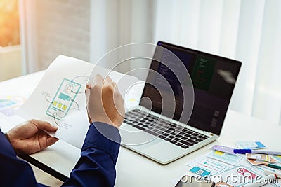 Designer man mobile application test new app features. He working with sketch drawing application and create coding program on Stock Photo