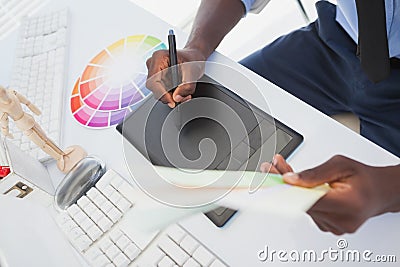 Designer sitting at his desk working with digitizer Stock Photo