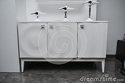 Designer and unique royal white laminated furniture set with two opening door and artifacts on top of it Stock Photo