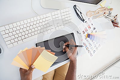 Designer using digitizer and colour wheel Stock Photo