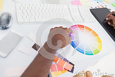 Designer using graphics tablet and colour wheel Stock Photo