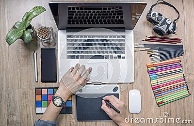 designer using laptop computer and graphics tablet at home office Stock Photo