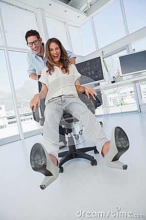 Designers having fun with on a swivel chair Stock Photo